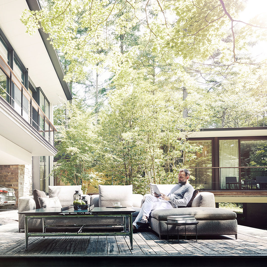 Man sitting outside and reading a magazine
