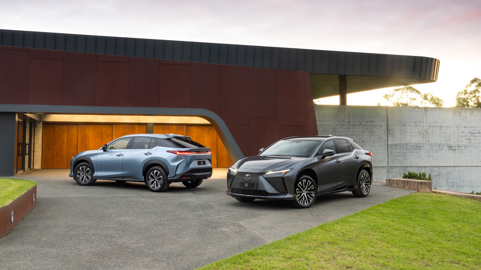 Light blue and dark grey RZ parked on a concrete driveway.