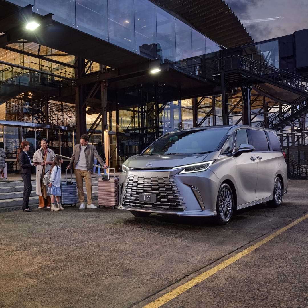 A family load their luggage into a Lexus LM at the airport arrivals zone